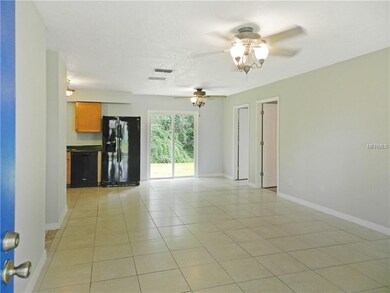 View of living room and dining room from front doo