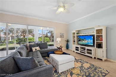 Living room featuring ceiling fan, ornamental mold