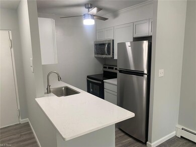 Kitchen with white cabinetry, stainless steel appl
