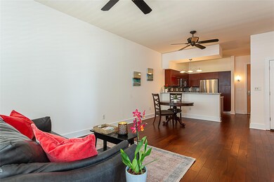 Living room with ceiling fan, baseboards, and dar