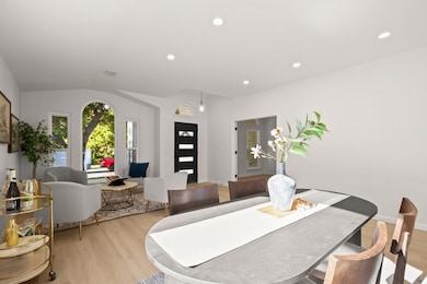 Dining room with recessed lighting, light wood finished floors, and vaulted ceiling