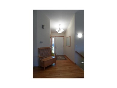Entryway. Front foyer with hardwood floor, seating
