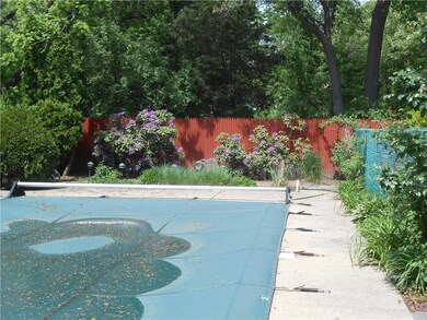 In ground Pool with slide and cement patio.