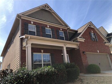 Craftsman house with brick siding and an attached garage
