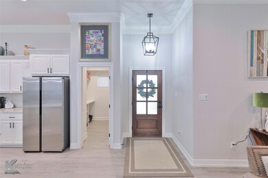 Entrance foyer with crown molding and light hardwo