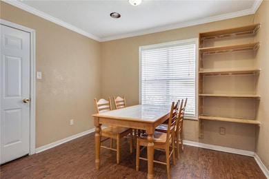 Dining area featuring wood finished floors, basebo