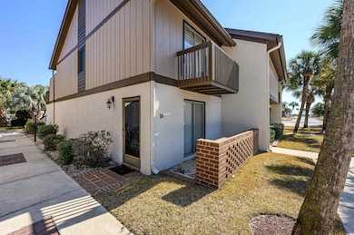 View of property exterior featuring a balcony and 