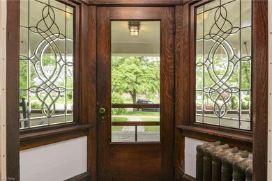 Gorgeous Leaded and beveled glass flank the original front door in the foyer.
