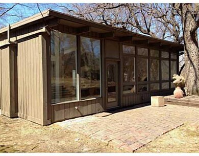 Exterior Back. Large windows provide abundant natu