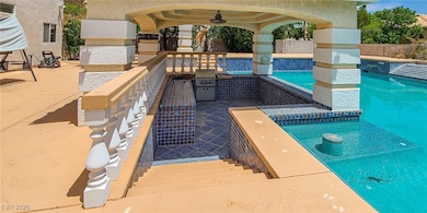 View of pool with a patio, a ceiling fan, a fenced backyard, and grilling area