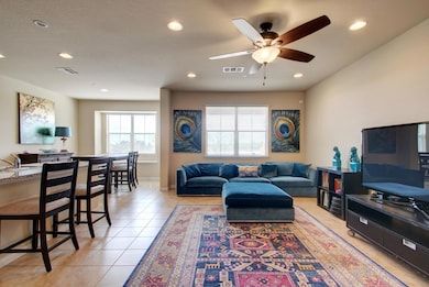 Living room with visible vents, ceiling fan, rece