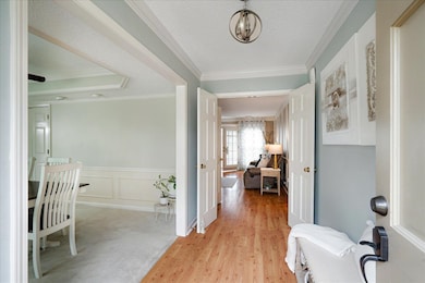 Corridor featuring a textured ceiling, a decorativ