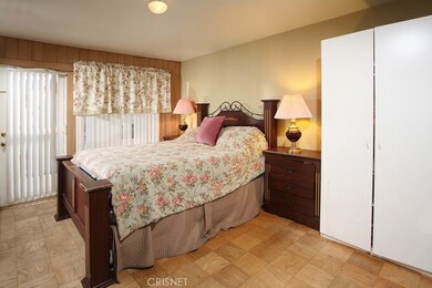 The large master bedroom is drenched in natural light, has direct backyard access, and is further highlighted by its ample closet with custom built-in organizers to maximize storage, striking hardwood flooring, and private bathroom.