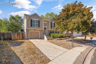 Split foyer home featuring board and batten siding, driveway, and a garage