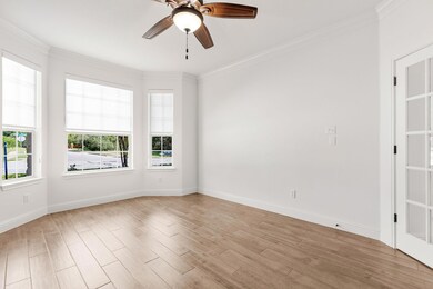 Empty room with light wood finished floors, ornam