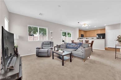 Living room, light colored carpet.
