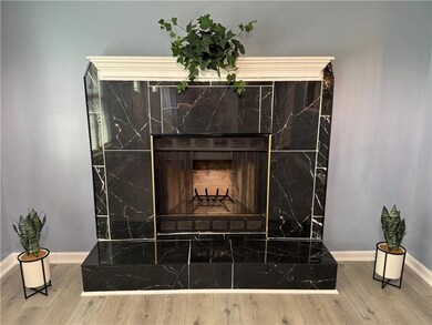 Detailed view of wood finished floors and Fireplace