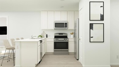 Kitchen with a peninsula, a sink, white cabinets, 