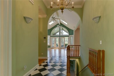 Entrance hall with striking tile floor, vaulted ce