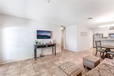 Living room with light tile patterned floors and baseboards