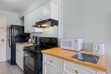 Kitchen featuring a sink, butcher block countertop