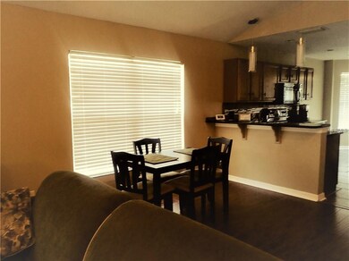 Dining area with breakfast bar--has wood flooring.