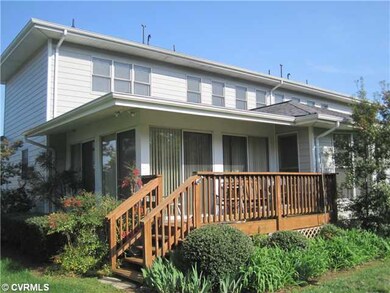 Exterior Back - A deck that overlooks a pond and t