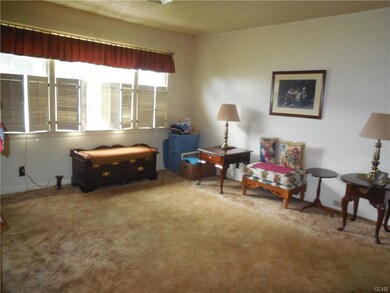 spacious living room with window shutters for plen