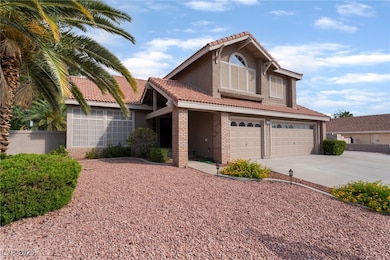 Traditional-style home featuring a garage, a tiled