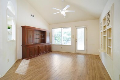 Kitchen with white cabinets, stainless steel appliances, sink, tasteful backsplash, and dark stone countertops