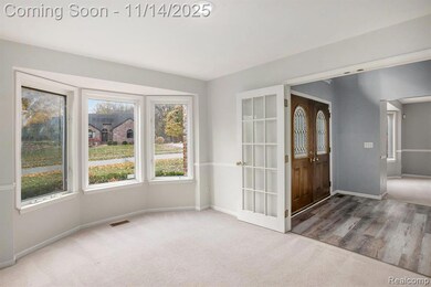 Carpeted empty room with baseboards and french doors
