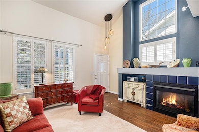 Living room with large windows and gas fireplace. Notice the dramatic entryway light fixture.