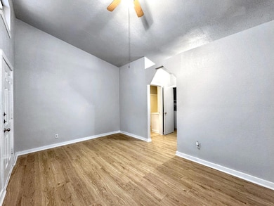 Empty room featuring a textured ceiling, baseboar