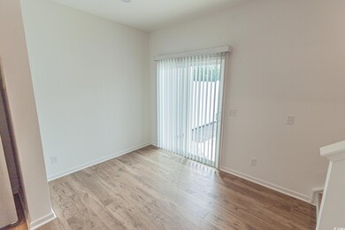 Empty room with wood finished floors and baseboards
