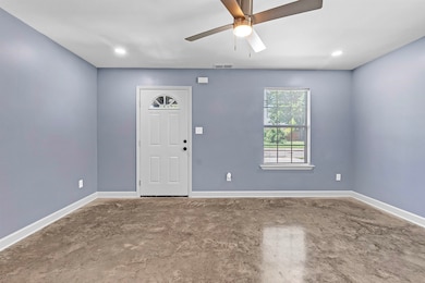 Foyer entrance featuring a ceiling fan, concrete flooring, and recessed lighting