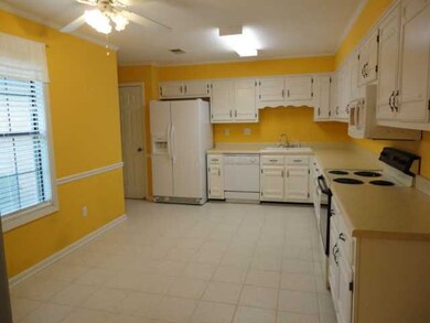 A generous kitchen with lots of counter tops and c