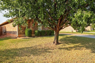 View of front of property featuring a front lawn and brick siding