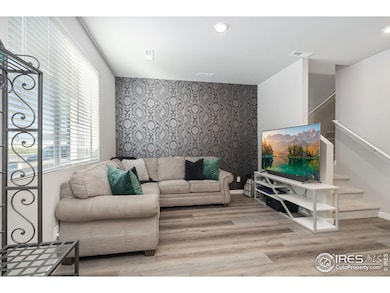 Living room with on-trend accent wall and loads of natural light.