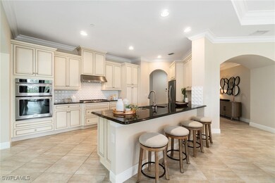 Kitchen with cream cabinets, a sink, appliances wi