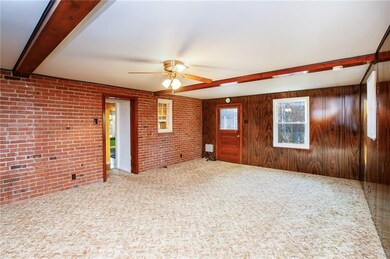 Wood paneling, Beams, ceiling fan, brick in carpet