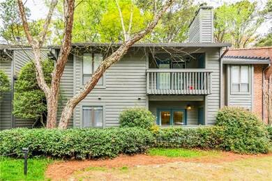Rear view of property featuring a balcony and a ch