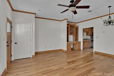 Unfurnished living room with ceiling fan with nota