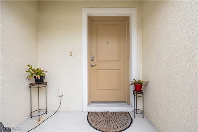 View of exterior entry with stucco siding