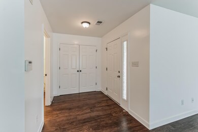 Corridor with dark hardwood / wood-style floors