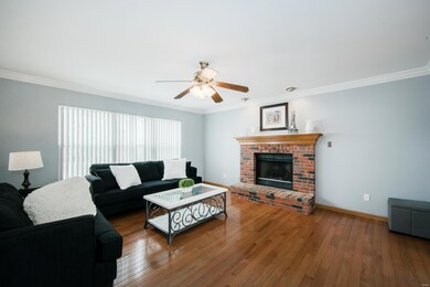 A brick gas fireplace with a wood mantle and big b