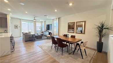 Dining area with a ceiling fan, light wood finishe