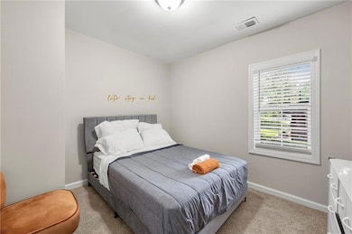 Carpeted bedroom featuring baseboards