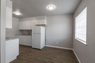 Kitchen with dark wood-style flooring, freestandi