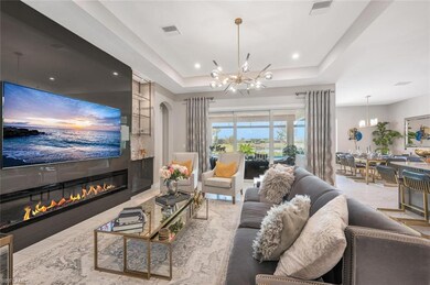 Living area with a notable chandelier, a raised ce