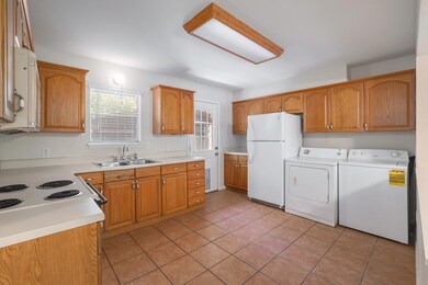 Kitchen featuring white appliances, washing machi